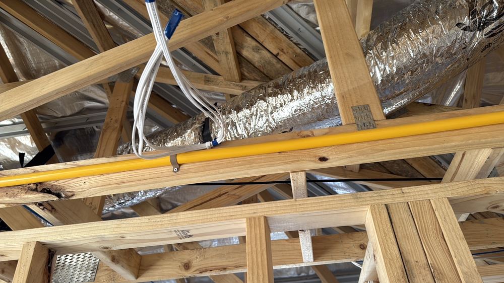 Electrical cable touching a gas pipe, where 25mm of separation is required, found during a lock-up inspection in Wollert